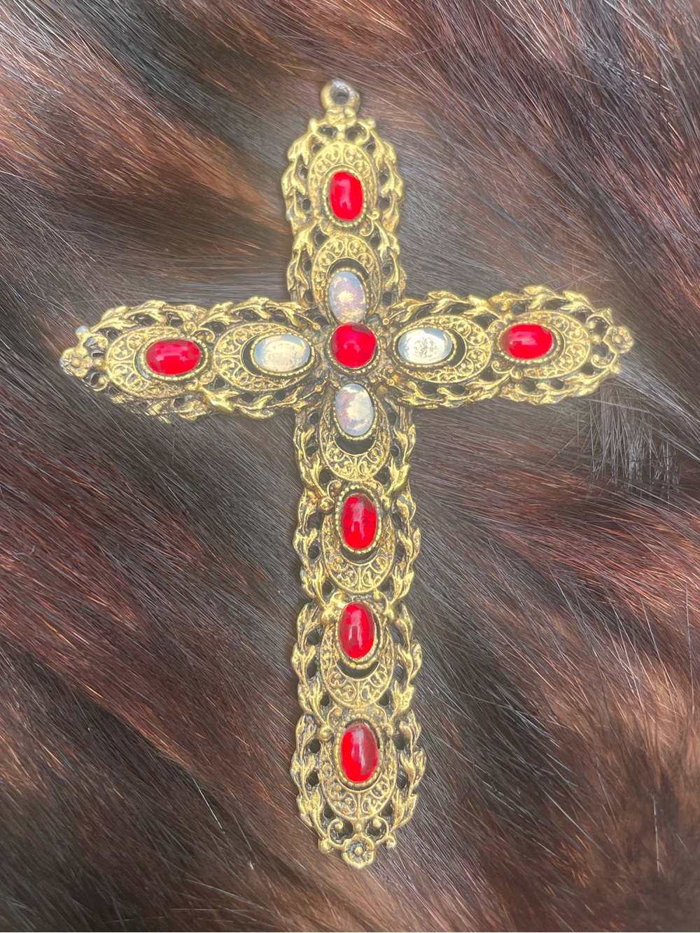 Vintage Celebrity gold tone cross with moonstone-like and ruby-like stones